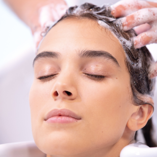 Woman getting her hair shampooed at the salon