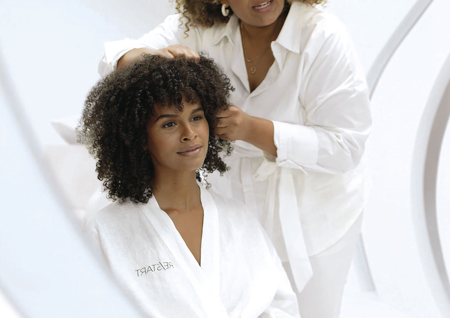 A woman who is having her hair washed, treated and naturally air-dried.